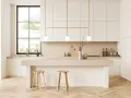 Cocina moderna y luminosa con isla central, taburetes de madera y detalles dorados. Perfecta para decorar cocina con estilo minimalista.