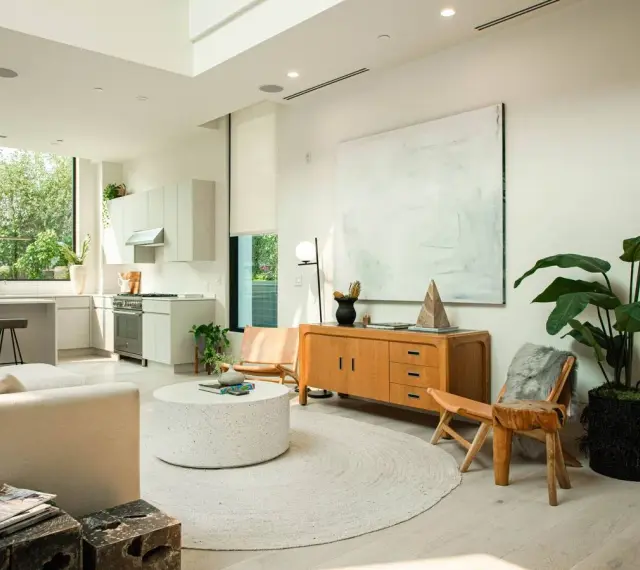 Un salón luminoso con cocina integrada, muebles de madera clara y decoración minimalista, reflejando un estilo nordico casa.