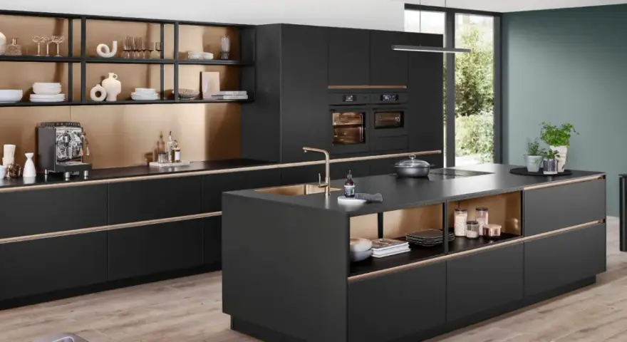 Elegantes cocinas pequeñas con isla central negra, gabinetes dorados y electrodomésticos integrados.